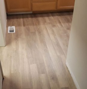 New plank flooring in a bathroom hallway