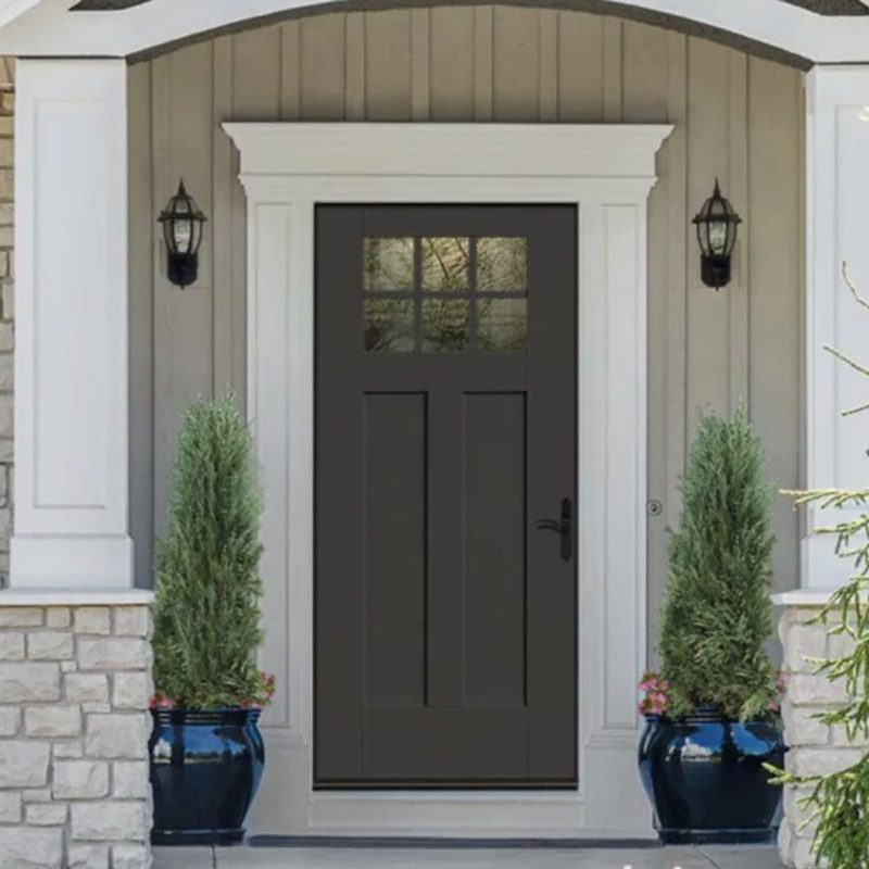 Dark craftsman front door with a six-light window, white trim and two lanterns