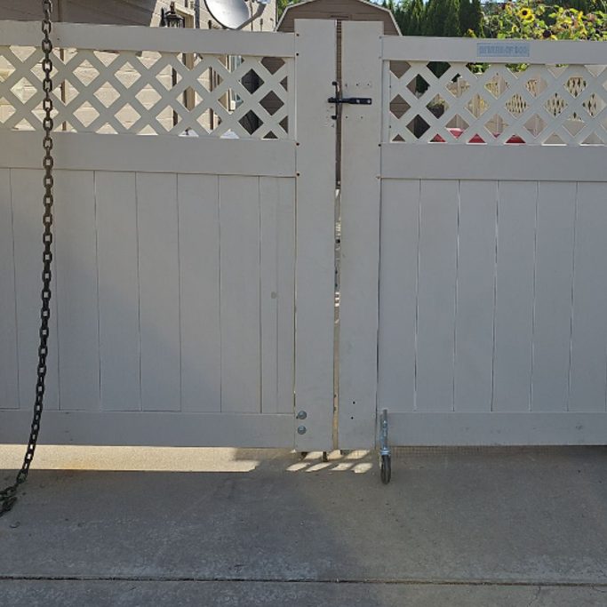 White vinyl double gate sagging out of line