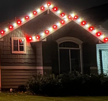 House roofline in red and white holiday lights